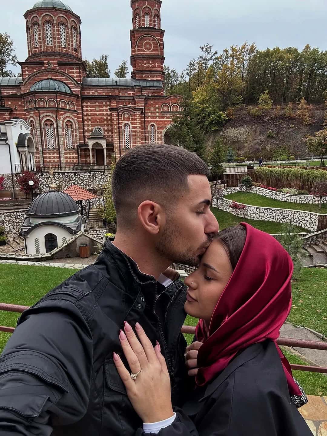 A couple in a church garden in autumn