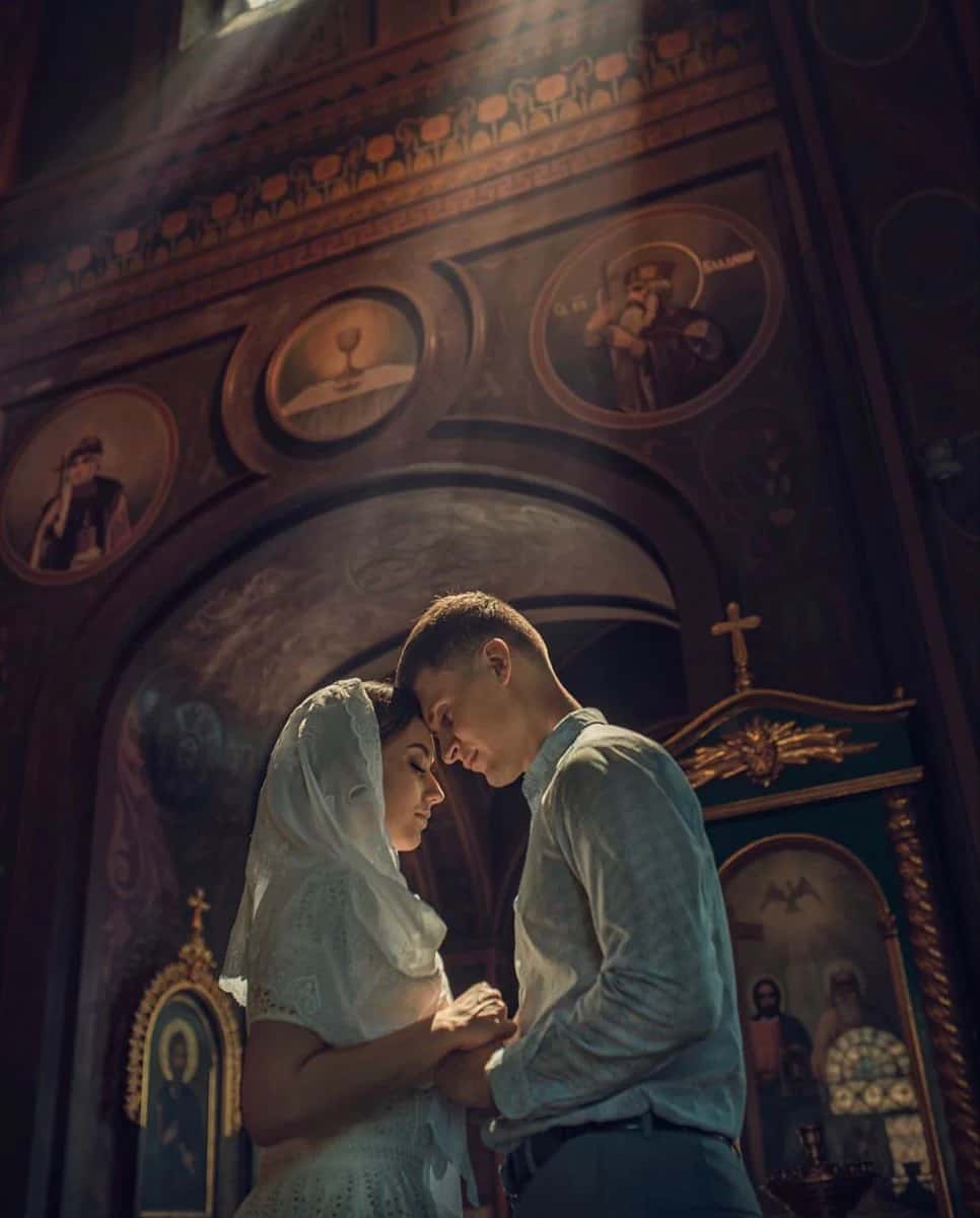 A couple holding hands in church