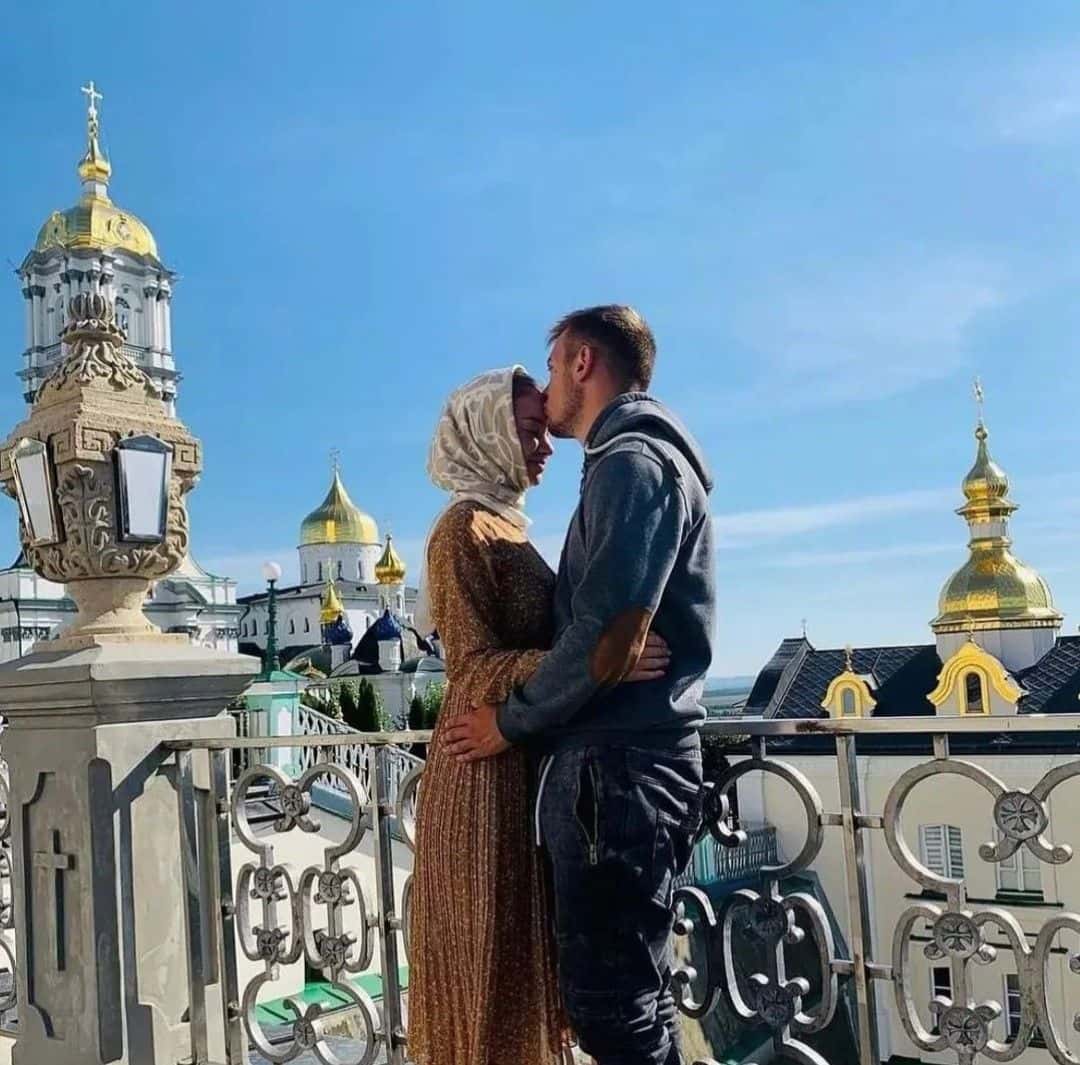 A couple at a monastery on a bright afternoon